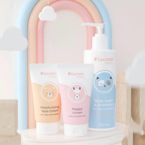 Three Nacomi baby care products on a white surface with a colorful arch in the background.