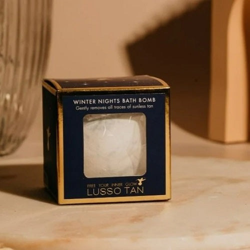 Lusso Tan Winter Nights Tan Removing Bath Bomb packaging on a marble surface
